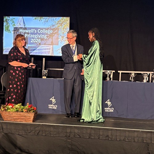 Master and teacher presenting an award to a student on stage